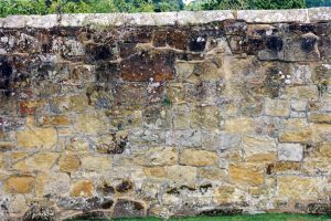 Old sandstone wall with capping