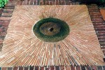 Old millstone, tile and brick paving detail